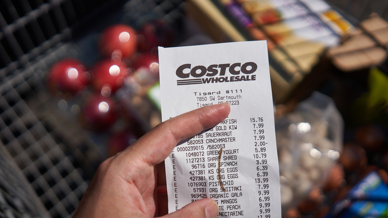 Hand holding a Costco receipt