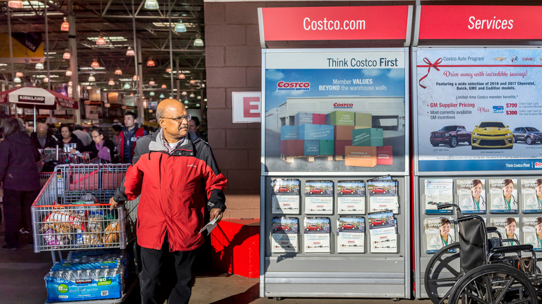 Man passing by Costco services kiosk