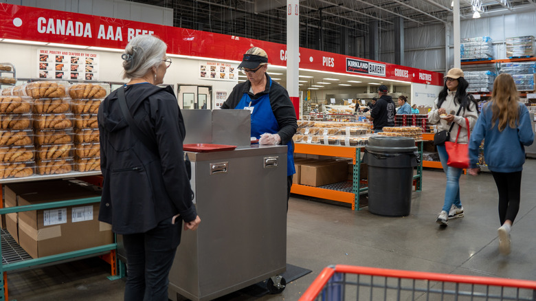 Woman handing out samples at a Costco warehouse