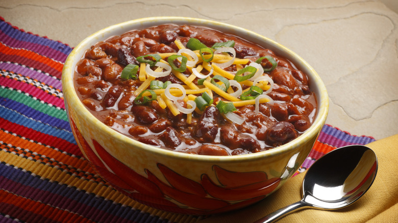 Bowl of chili on a bright colored placemat