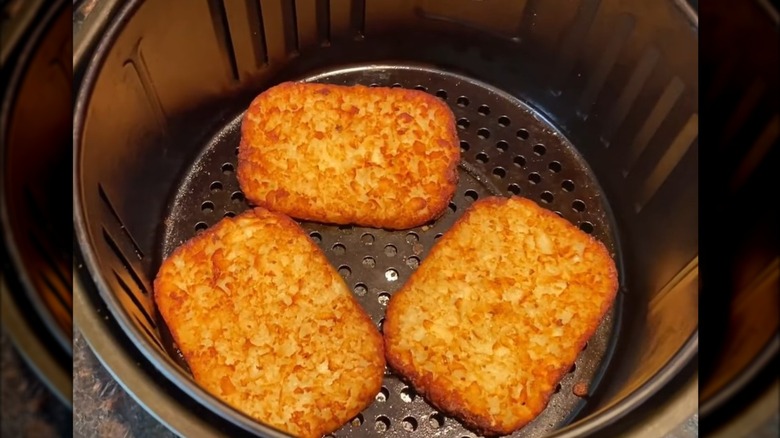 Hash browns reheated till golden in the air fryer basket