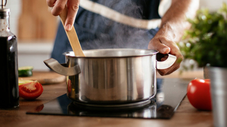 Cooking meal in pot on stove