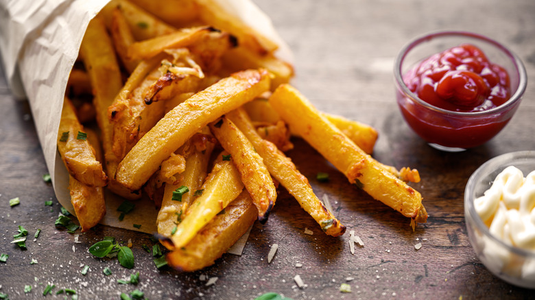 package of fries with condiments