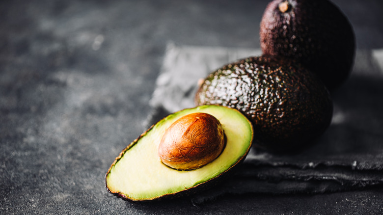 avocados on black background