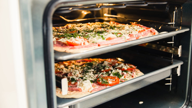 two pizza dishes in oven