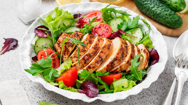 Chicken salad plated near board