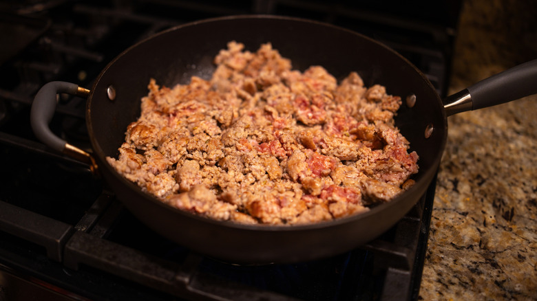 Sausage being cooked in pan