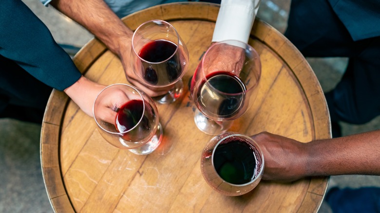 Hands holding red wine