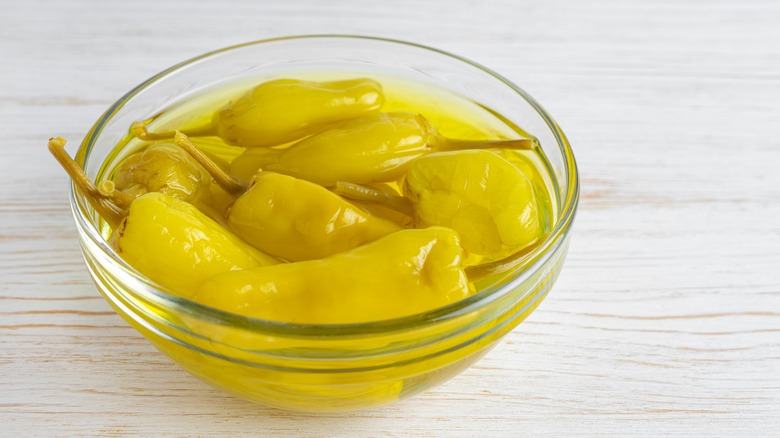 dish of pepperoncini in juice