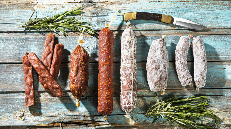 Assorted cured meats in stick shapes.