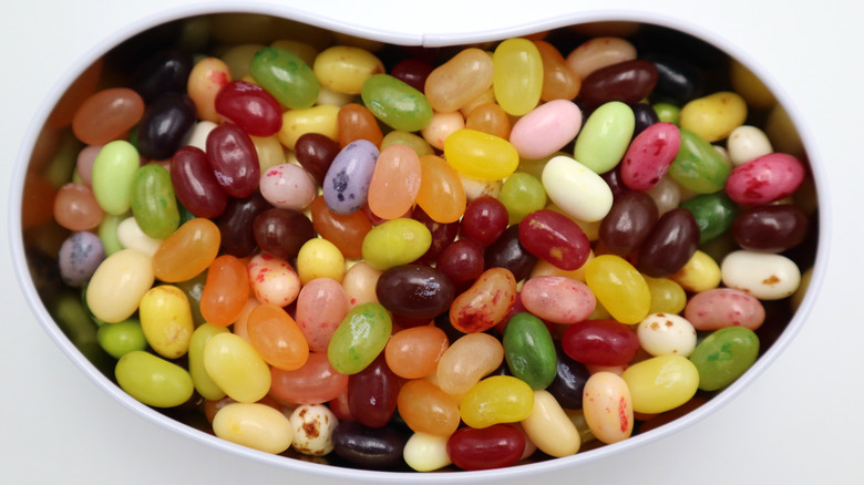 Pile of jelly beans in jelly bean-shaped container