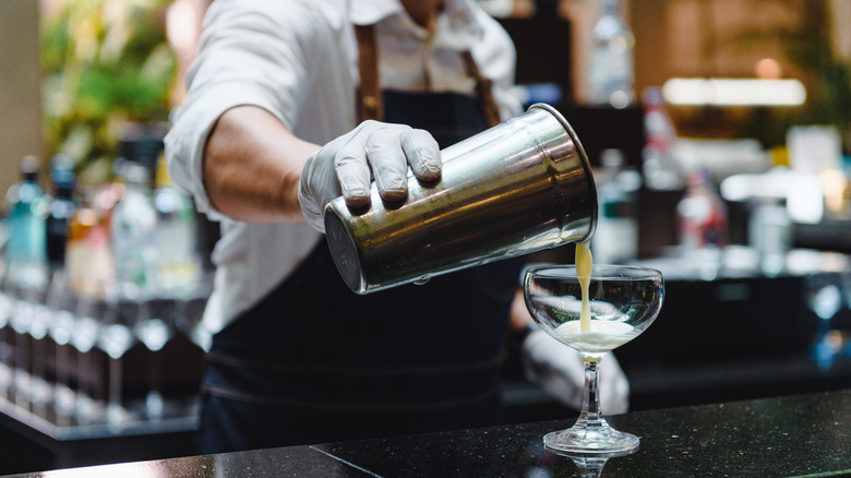 Bartender making drink on counter