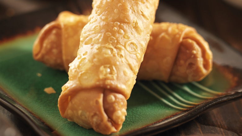 Two egg rolls on plate
