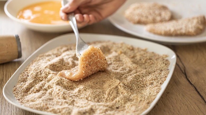 dunking meat into breading