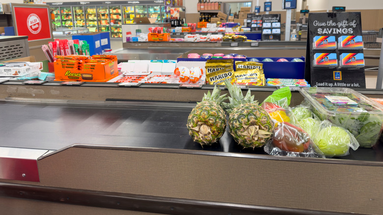 Aldi checkout area with pineapples on conveyor belt