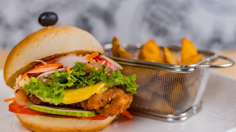 fried chicken thigh sandwich with home fries