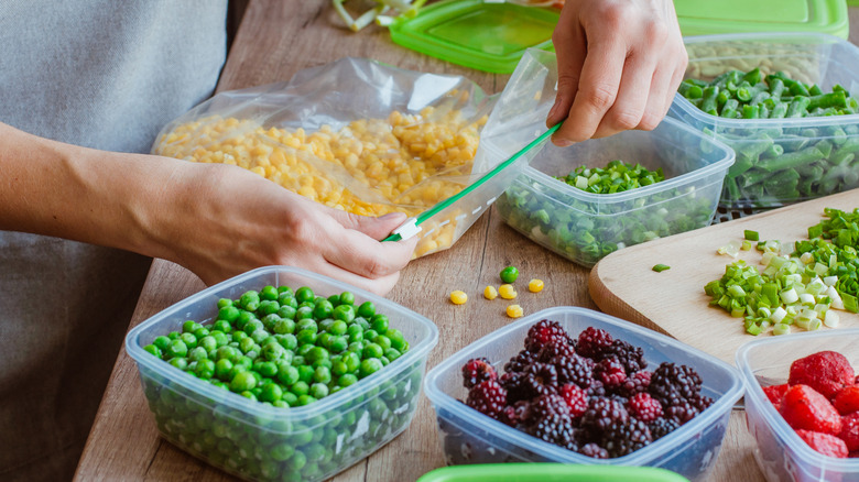 Person storing corn and other vegetables for freezing