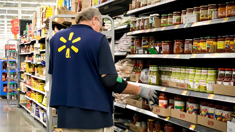 Walmart employee stocking shelves