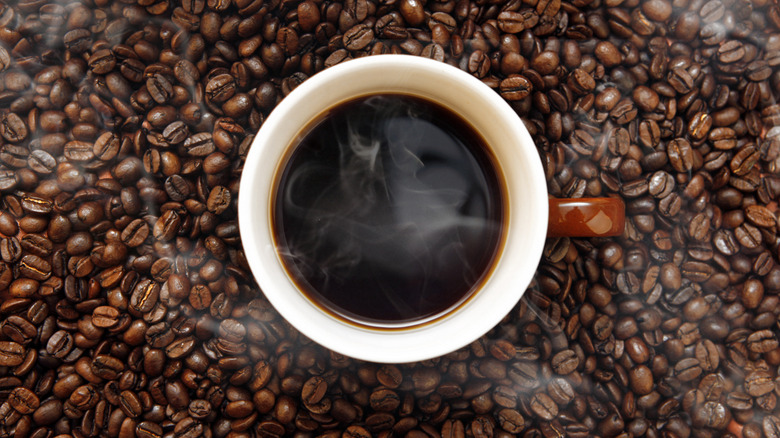 cup of black coffee with coffee beans