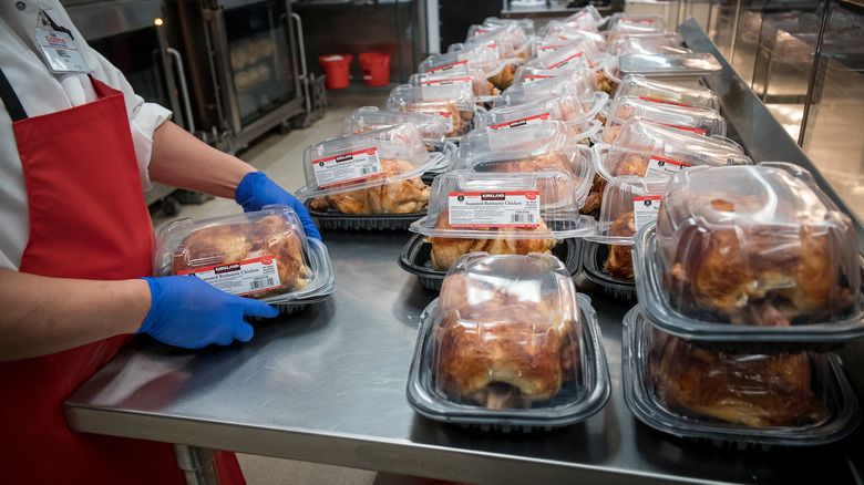 Costco employee packaging rotisserie chicken