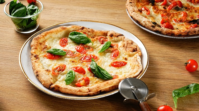 Full thin crust pizza on plate