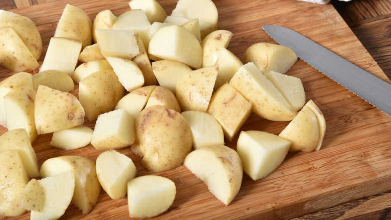 Cut yukon gold potatoes on wood board