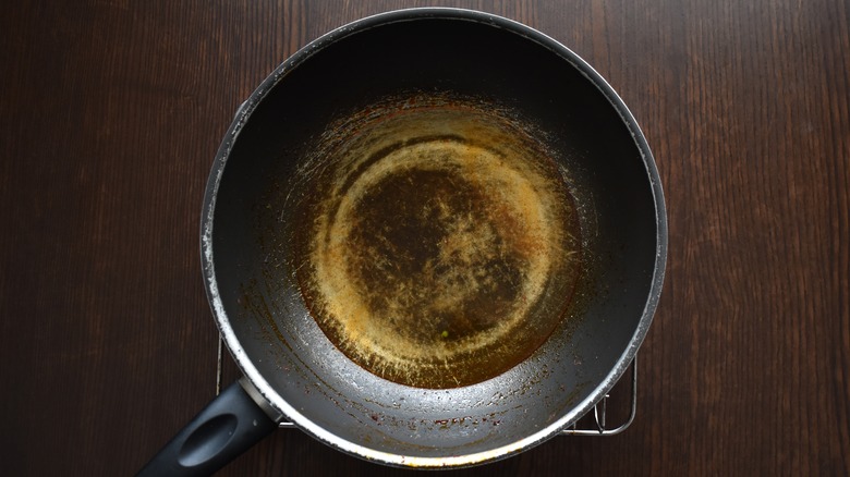 Scratched wok with rust