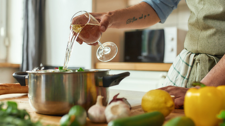 pouring wine into pan