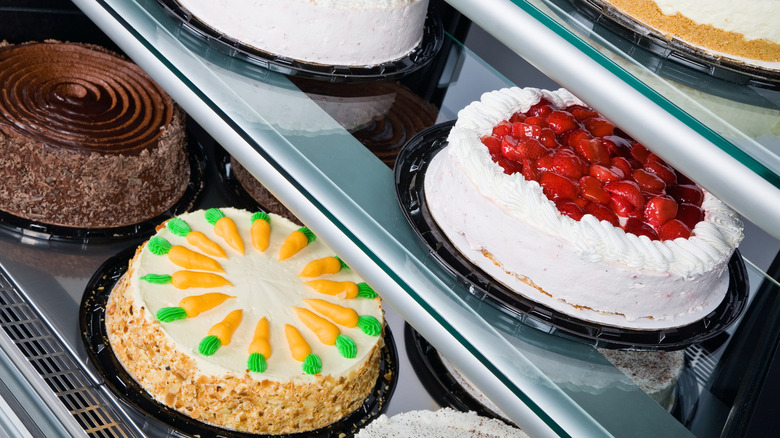 Cakes in grocery store bakery case