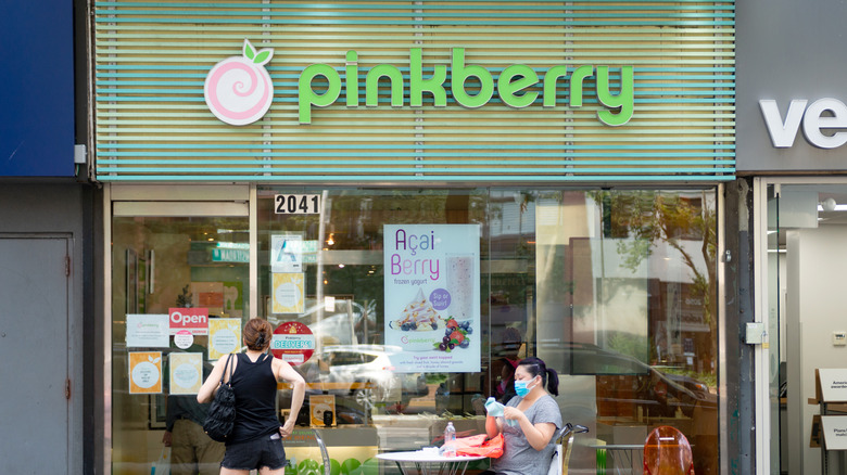 Woman sitting at table in front of Pinkberry