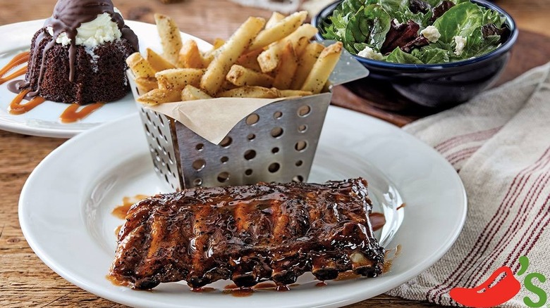 Plate with Chili's baby back ribs and fries, with salad and dessert