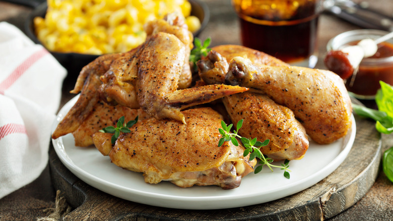 Plate with pieces of roasted chicken on it.