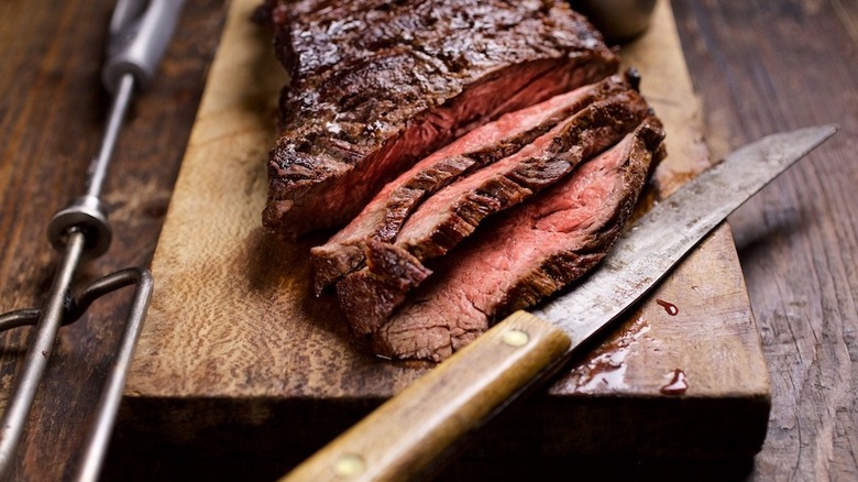 Sliced steak on board