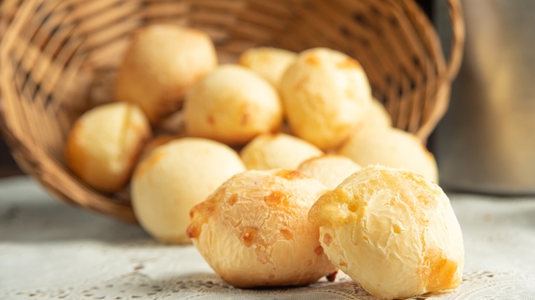 Dinner rolls falling out of a bread basket