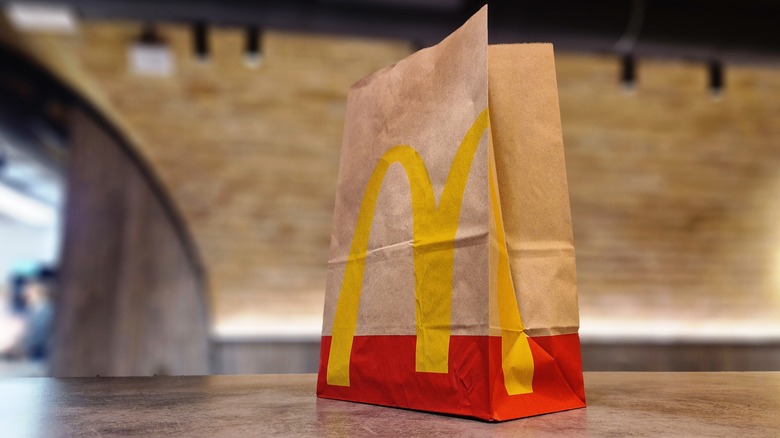 A paper McDonald's bag on a counter
