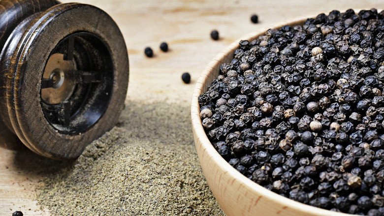 Peppercorns and pepper miller