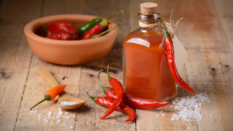 hot sauce on table with peppers