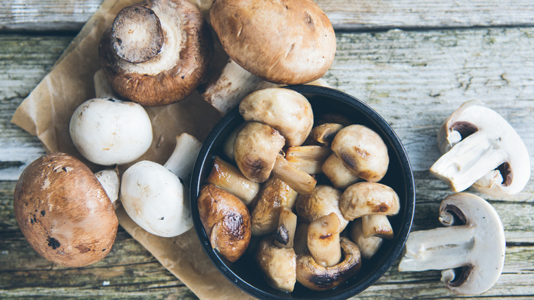 Button mushrooms on a board