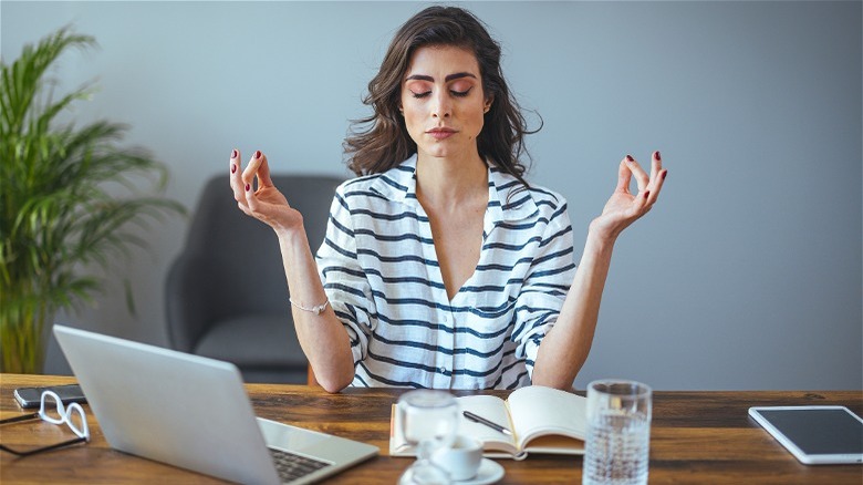 Woman deep breathing at desk