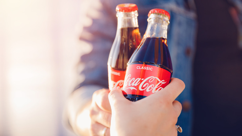 Clinking glass coke bottles
