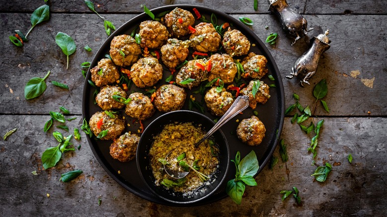 Plate of meatballs with chopped herbs 