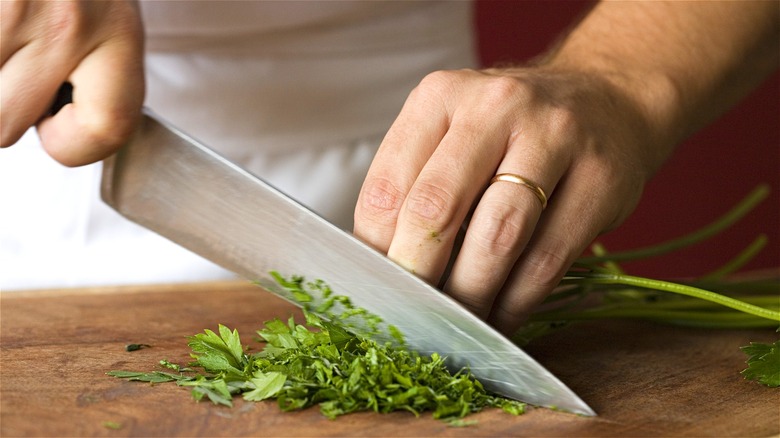 Hands chopping herbs 