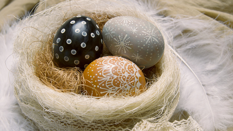 earth-tone eggs in rustic nest