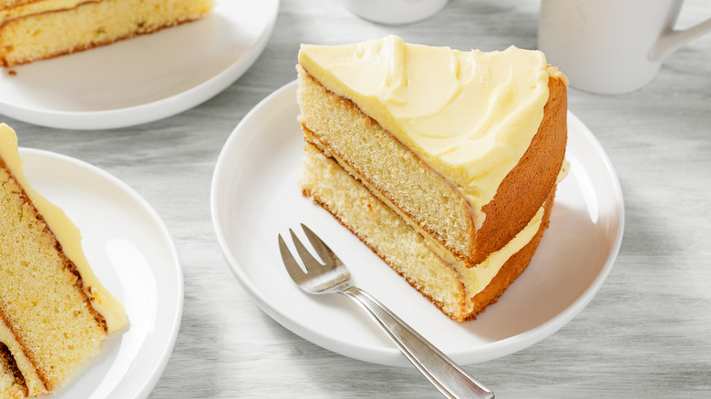 slice of layered cake on plate with fork