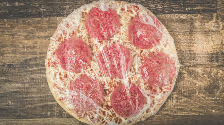 Frozen salami pizza in packaging