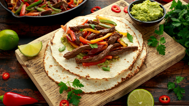 Steak fajitas on wooden board