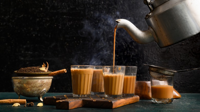 A hot stream of tea is poured into cups