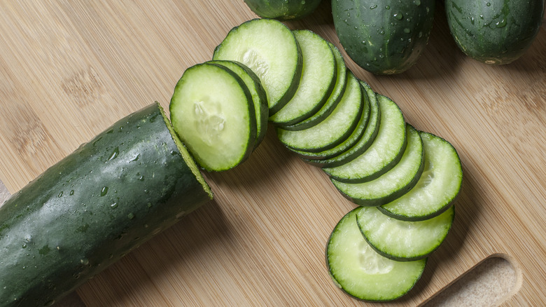 Sliced cucumber on cutting board