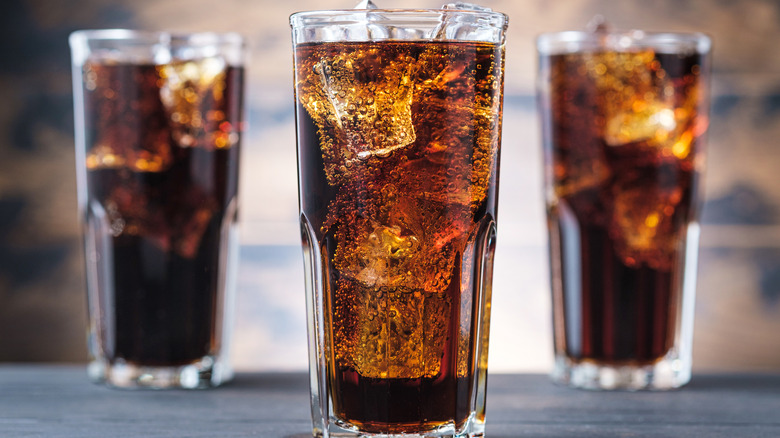 Three glasses of fizzy cola