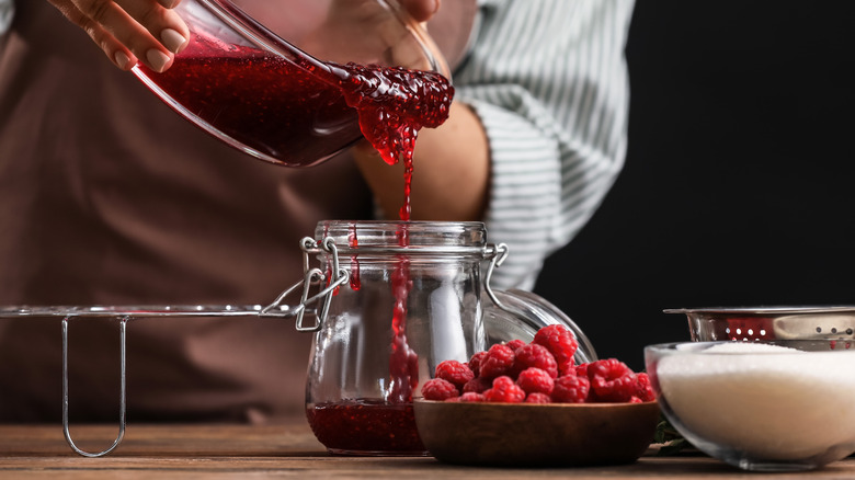 Pouring jam into a glass jar